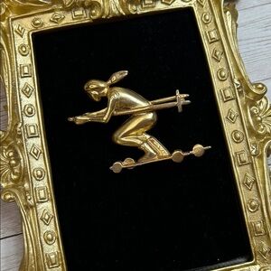 Vintage gold-tone designer-signed Elle skier brooch